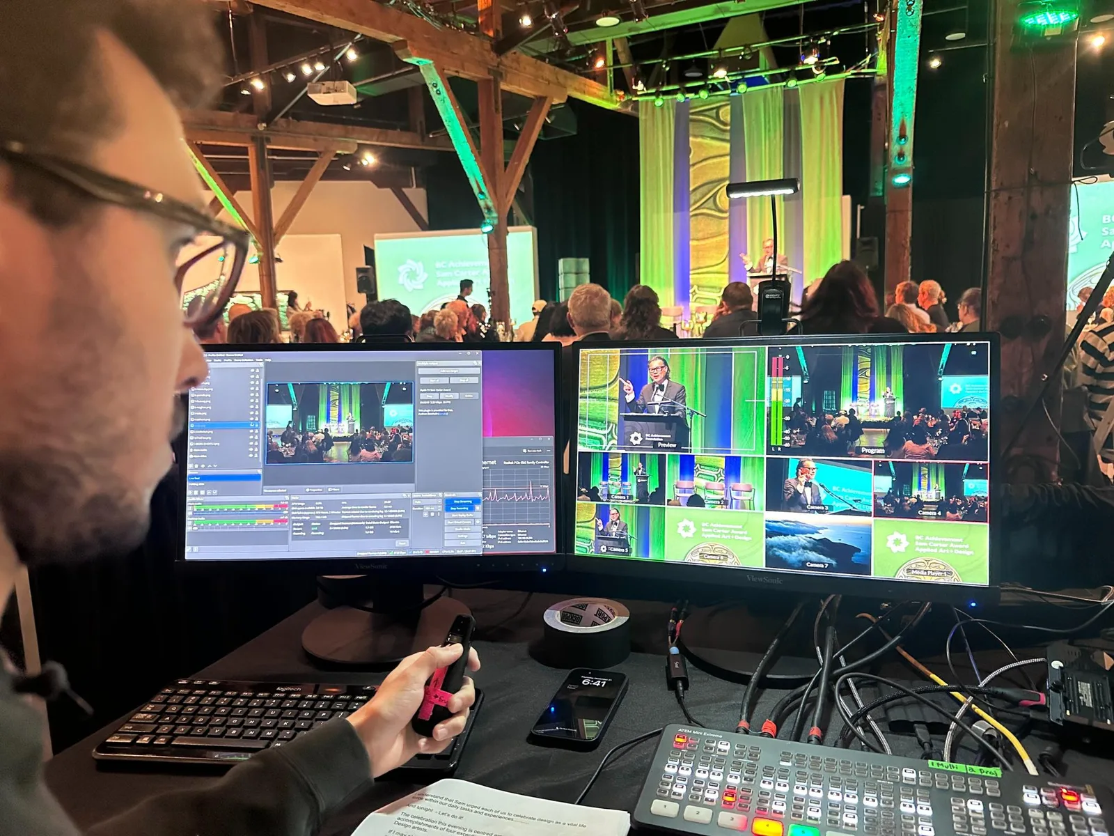 A volunteer running the production desk at a service