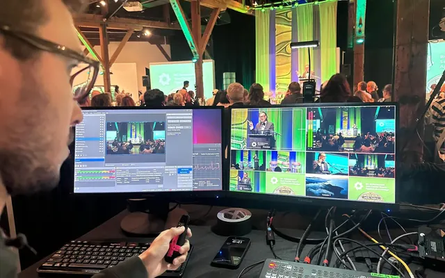 A volunteer running a church service from the production desk