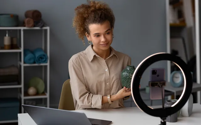 A creator streaming from her desk with a ring light